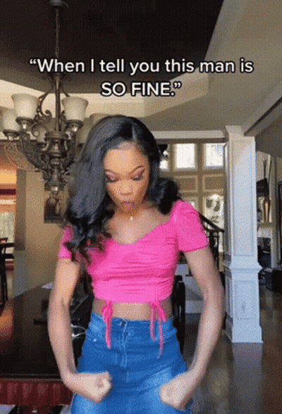 A Woman In A Pink Top Says " When I Tell You This Man Is So Fine " In A Living Room GIF