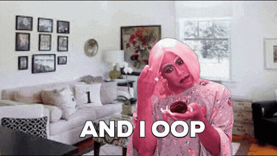 A Woman In A Pink Wig Is Holding A Cupcake And Says " And I Oop " GIF