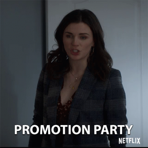A Woman In A Plaid Jacket Stands In Front Of A Sign That Says Promotion Party Netflix GIF