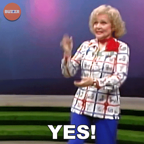 A Woman In A Plaid Shirt And Blue Jeans Says Yes GIF