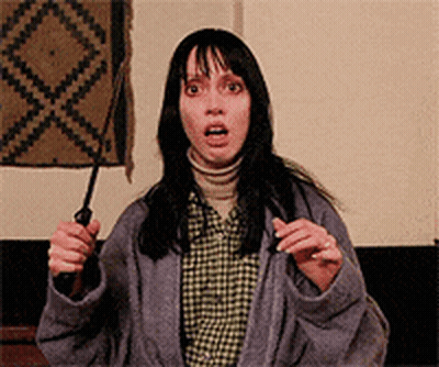 A Woman In A Plaid Shirt Is Holding A Knife GIF