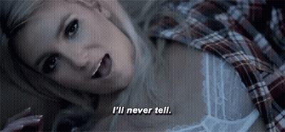 A Woman In A Plaid Shirt Is Laying Down And Says I 'Ll Never Tell GIF