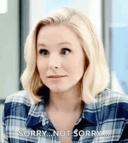 A Woman In A Plaid Shirt Is Making A Funny Face And Saying Sorry . GIF