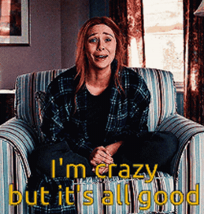 A Woman In A Plaid Shirt Is Sitting In A Chair With The Words " I 'M Crazy But It 'S All Good " GIF