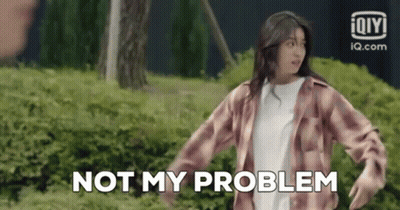 A Woman In A Plaid Shirt Is Standing In Front Of A Bush . GIF