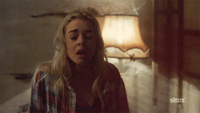A Woman In A Plaid Shirt Is Standing In Front Of A Lamp With The Word Starz On The Bottom GIF
