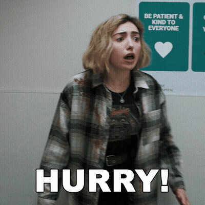 A Woman In A Plaid Shirt Is Standing In Front Of A Sign That Says Hurry GIF