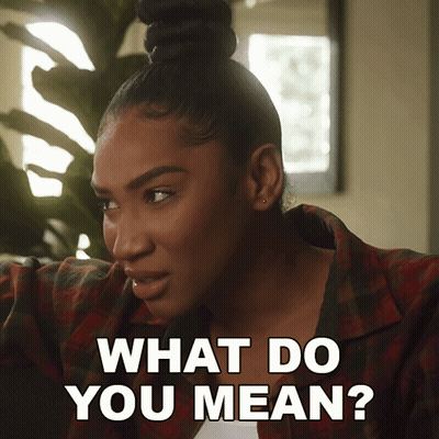 A Woman In A Plaid Shirt Says " What Do You Mean " GIF