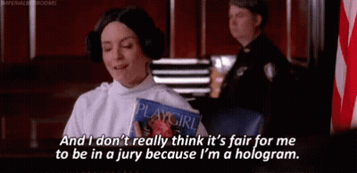 A Woman In A Playgirl Costume Is Sitting In A Courtroom Holding A Playgirl Magazine . GIF