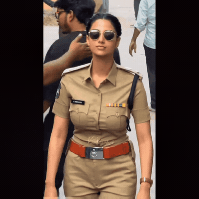 A Woman In A Police Uniform Has A Name Tag On Her Chest That Says ' S. Krishna ' GIF
