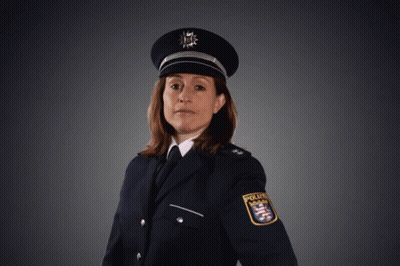 A Woman In A Police Uniform Is Pointing Her Finger GIF