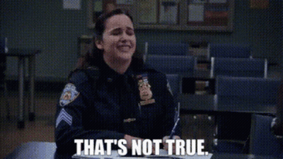 A Woman In A Police Uniform Is Sitting At A Desk In A Classroom And Saying `` That 'S Not True '' . GIF