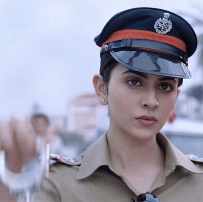 A Woman In A Police Uniform With A Badge That Says ' Delhi ' On It GIF