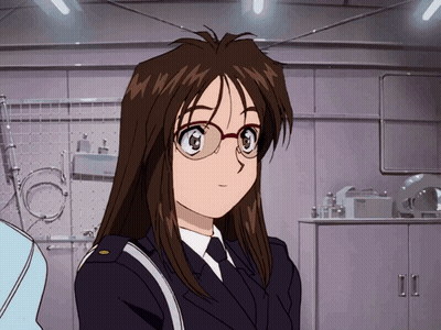 A Woman In A Police Uniform With Glasses Stands In Front Of A Shelf That Says Bosch GIF