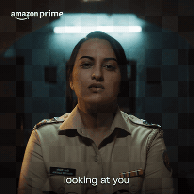 A Woman In A Police Uniform With The Words Amazon Prime Looking At You GIF