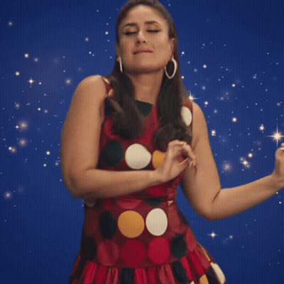 A Woman In A Polka Dot Dress Is Dancing GIF