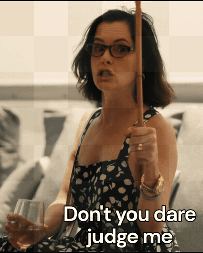 A Woman In A Polka Dot Dress Is Holding A Cane And Says " Don T You Dare Judge Me " GIF