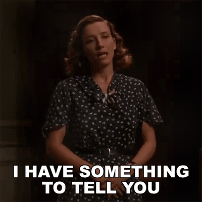 A Woman In A Polka Dot Dress Says I Have Something To Tell You . GIF