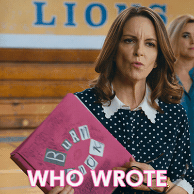 A Woman In A Polka Dot Shirt Is Holding A Pink Folder That Says Burn Book GIF