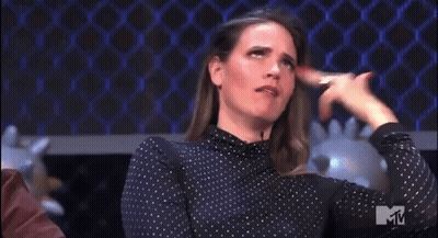 A Woman In A Polka Dot Shirt Is Making A Funny Face With The Letter M In The Corner GIF