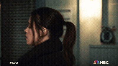 A Woman In A Ponytail Is Standing In Front Of A Sign That Says Nbc GIF