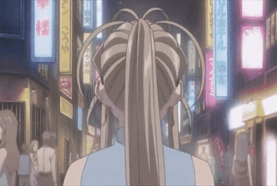 A Woman In A Ponytail Is Walking Down A Street With A Sign That Says ' A ' On It GIF