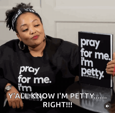 A Woman In A Pray For Me I 'M Petty Shirt Holds A Book GIF