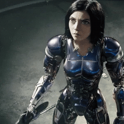A Woman In A Purple And Blue Armor Holds A Sword GIF