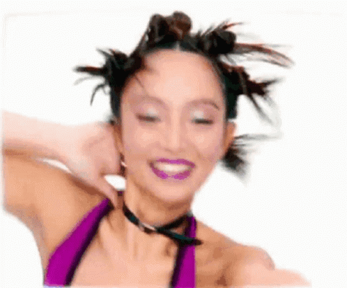 Woman In Purple Bikini Smiling With Hair In Bun GIF