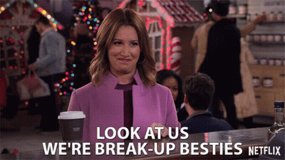 A Woman In A Purple Coat Says Look At Us We 'Re Break-Up Besties GIF