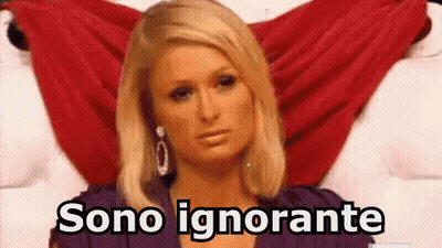 A Woman In A Purple Dress Is Sitting On A Bed With A Red Cloth Behind Her And The Words Sono Ignorante Above Her . GIF