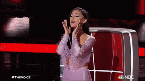 Woman In Purple Dress In Front Of NBC Screen GIF