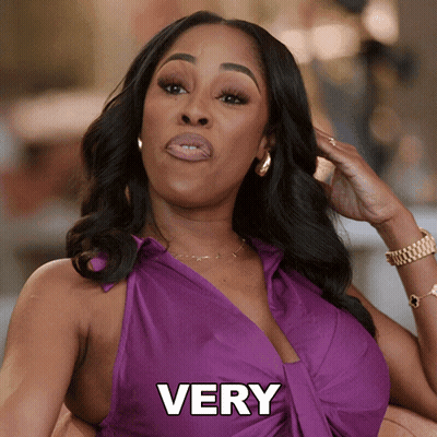 A Woman In A Purple Dress With The Word Very On The Bottom GIF