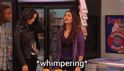 A Woman In A Purple Jacket Stands In Front Of A Handy Ho Quick Sign GIF