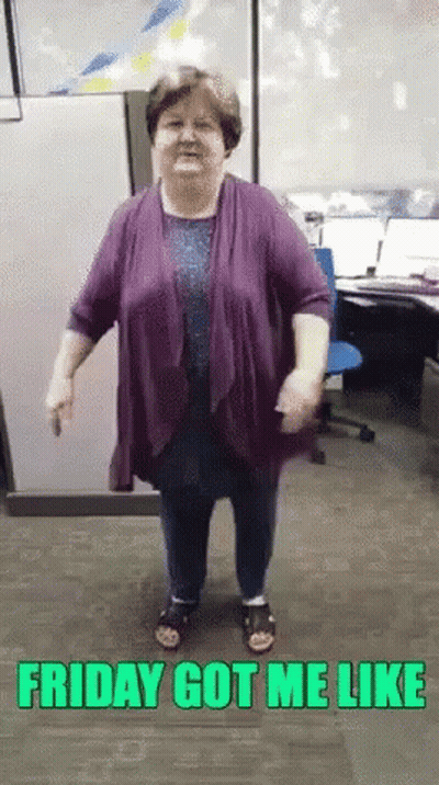 A Woman In A Purple Shirt Is Dancing In An Office With The Words Friday Got Me Like Above Her GIF
