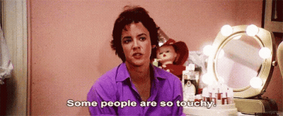 A Woman In A Purple Shirt Is Saying Some People Are So Touchy . GIF