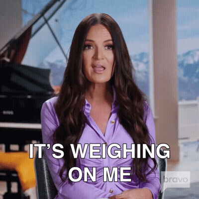 A Woman In A Purple Shirt Is Sitting In Front Of A Piano And Says It 'S Weighing On Me GIF