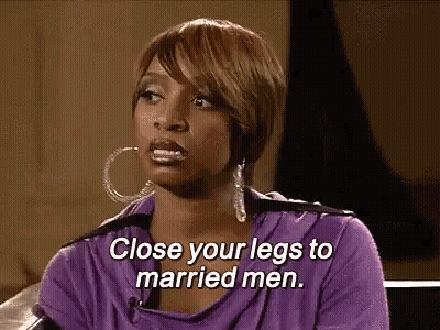 A Woman In A Purple Shirt Is Sitting On A Couch And Talking To A Married Man . GIF