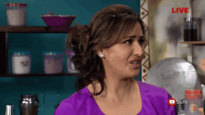 A Woman In A Purple Shirt Is Standing In Front Of A Live Sign GIF