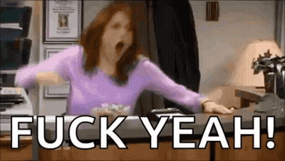 A Woman In A Purple Shirt Is Yawning While Sitting At A Desk With The Words `` Fuck Yeah '' . GIF