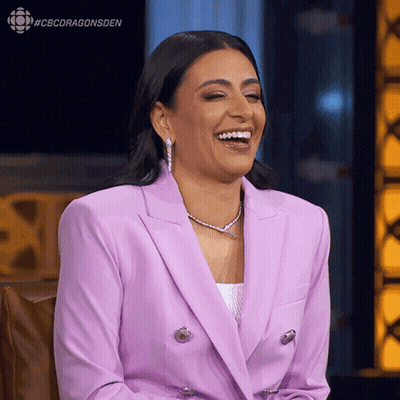 A Woman In A Purple Suit Is Laughing With The Hashtag #Cbcdragonsden Above Her GIF