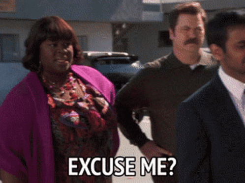 A Woman In A Purple Sweater Is Asking Someone To Excuse Her GIF
