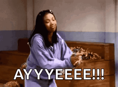 A Woman In A Purple Sweatshirt Says Ayy Yeee GIF