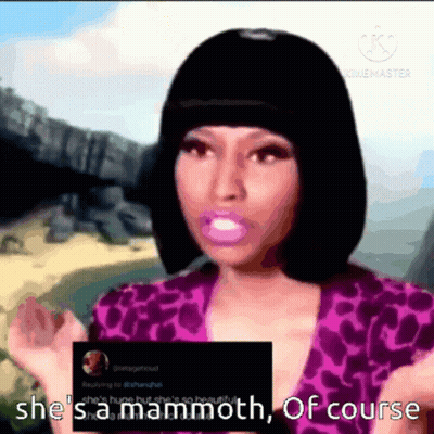 A Woman In A Purple Top Is Holding A Card That Says She 'S Mammoth Of Course GIF