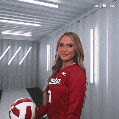 A Woman In A Red Alaska Jersey Holds A Volleyball In Her Hand GIF