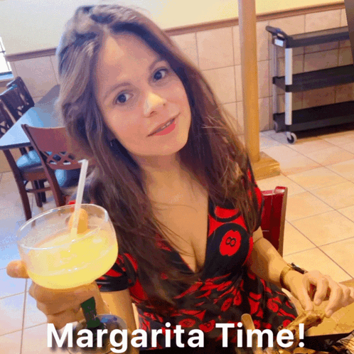A Woman In A Red And Black Dress Holds A Margarita In Her Hand GIF