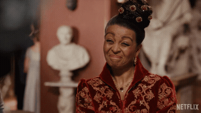 A Woman In A Red And Gold Dress With A Netflix Logo On The Bottom GIF