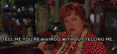 A Woman In A Red And White Polka Dot Shirt Is Talking To Someone . GIF