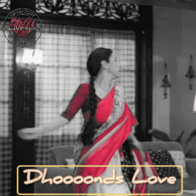 A Woman In A Red And White Saree Is Dancing In A Living Room GIF