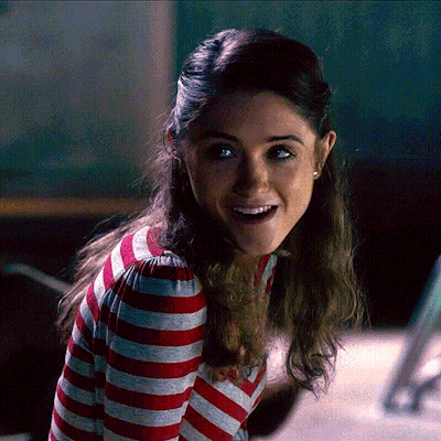 A Woman In A Red And White Striped Shirt Is Smiling GIF
